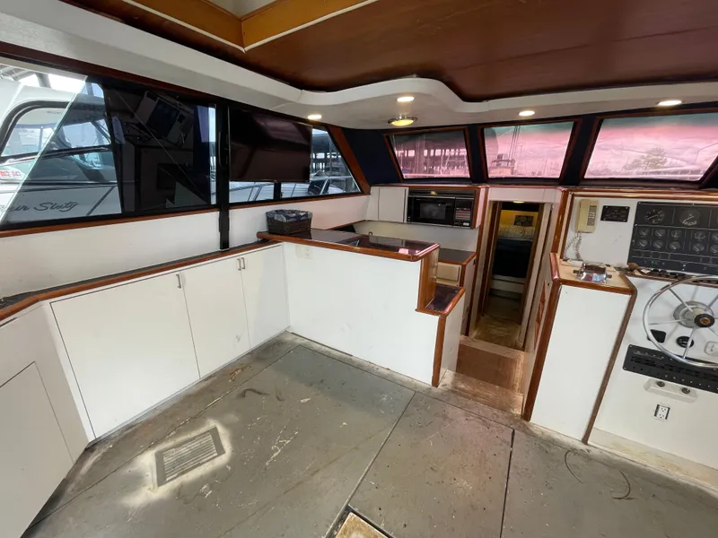Slide: The Image of Interior of a 1990 Tiara Yachts 4300 Convertible, featuring helm and cabin access. - 30