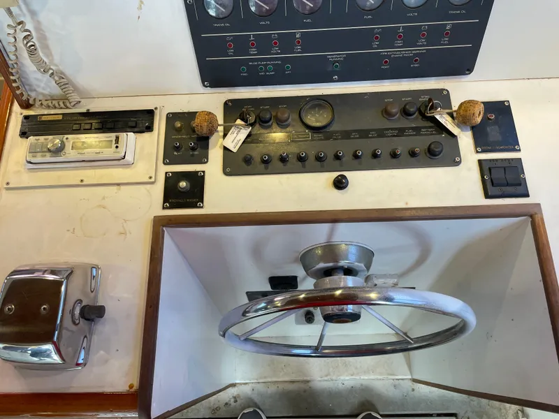 Slide: The Image of Control panel of a 1990 Tiara Yachts 4300 Convertible with steering wheel and instruments. - 33