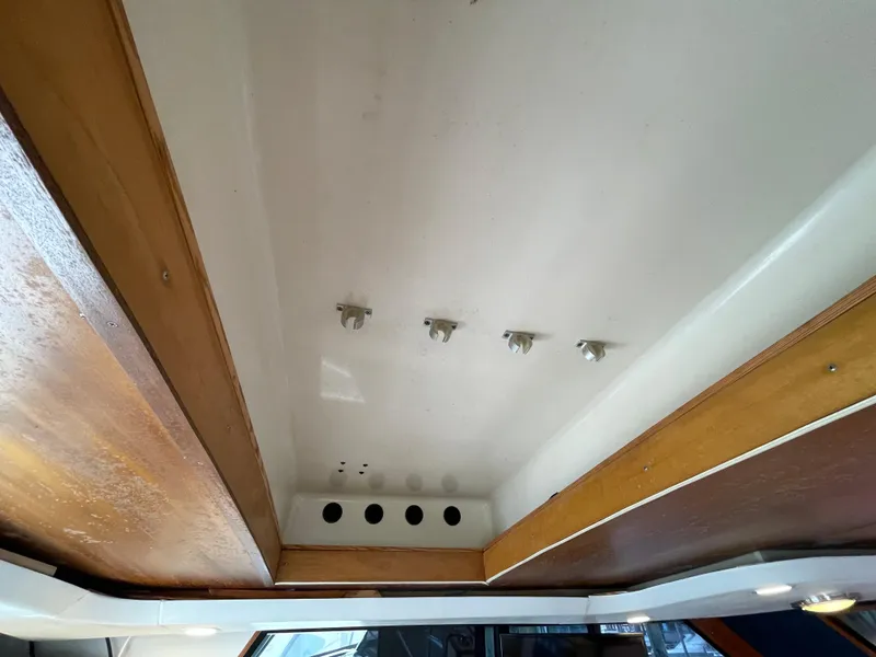Slide: The Image of Ceiling view of 1990 Tiara Yachts 4300 Convertible interior with wood accents. - 35