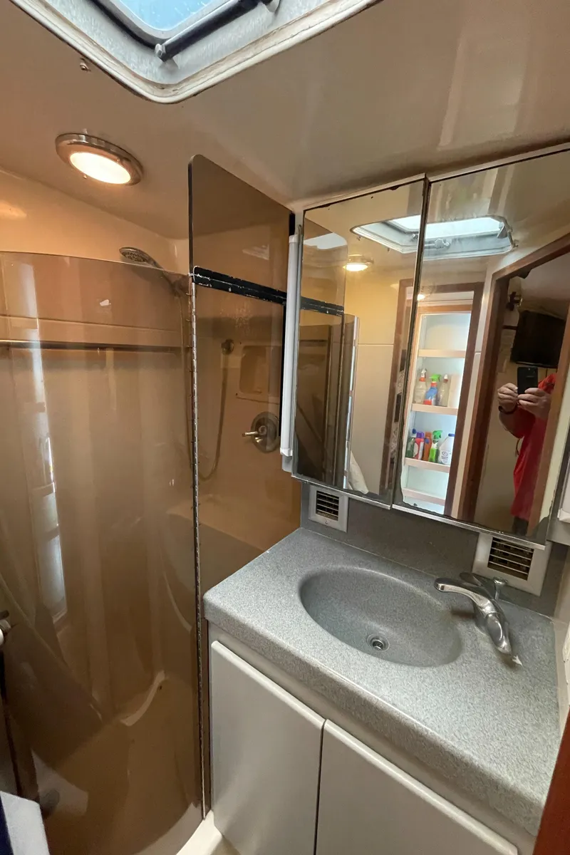Slide: The Image of 1990 Tiara Yachts 4300 Convertible bathroom with shower, sink, and mirrored cabinets. - 36