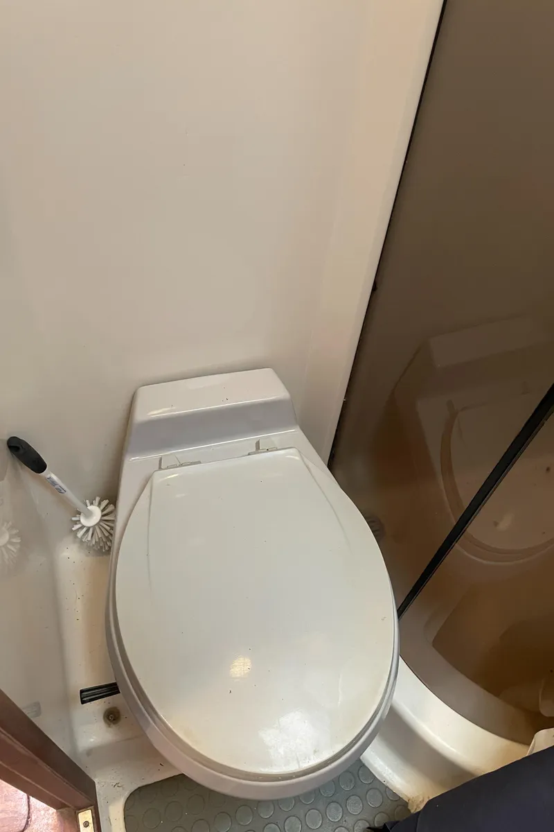 Slide: The Image of 1990 Tiara Yachts 4300 Convertible bathroom with toilet and shower area. - 37