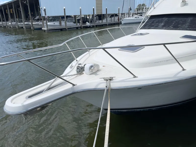 Slide: The Image of 1990 Tiara Yachts 4300 Convertible docked at marina, front view. - 8
