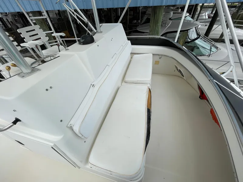 Slide: The Image of 1990 Tiara Yachts 4300 Convertible boat deck with white seating and helm station. - 9
