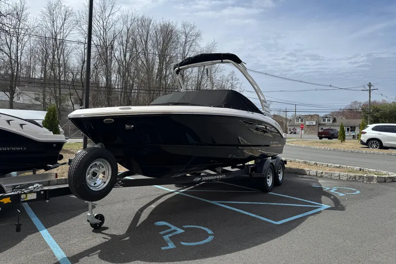 Slide: The Image of 2025 Chaparral 21 SSi IO boat, rear view, covered, parked outdoors. - 3