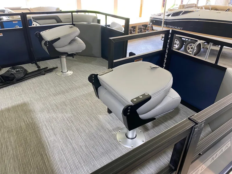 Slide: The Image of 2022 Viaggio Del Mar 18 Fish boat interior with swivel seats and carpeted flooring. - 7