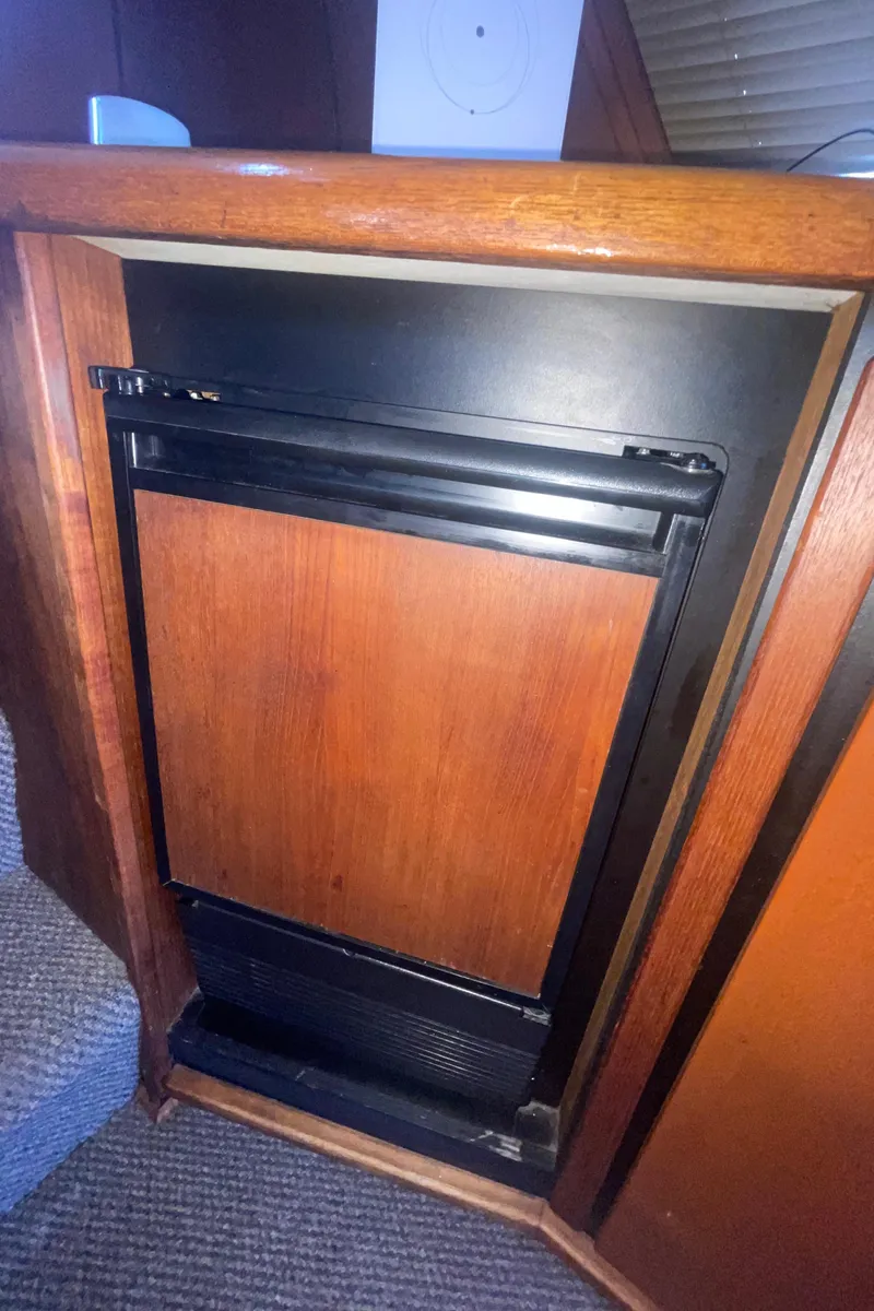 Slide: The Image of 1992 Bayliner 4588 Pilothouse interior with wooden cabinet and built-in appliance. - 10