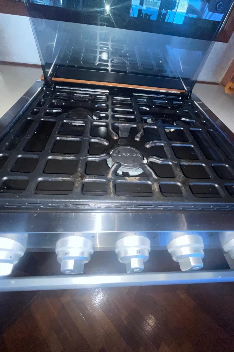 Slide: The Image of Gas stove with multiple burners and control knobs on a Bayliner 4588 Pilothouse yacht. - 12