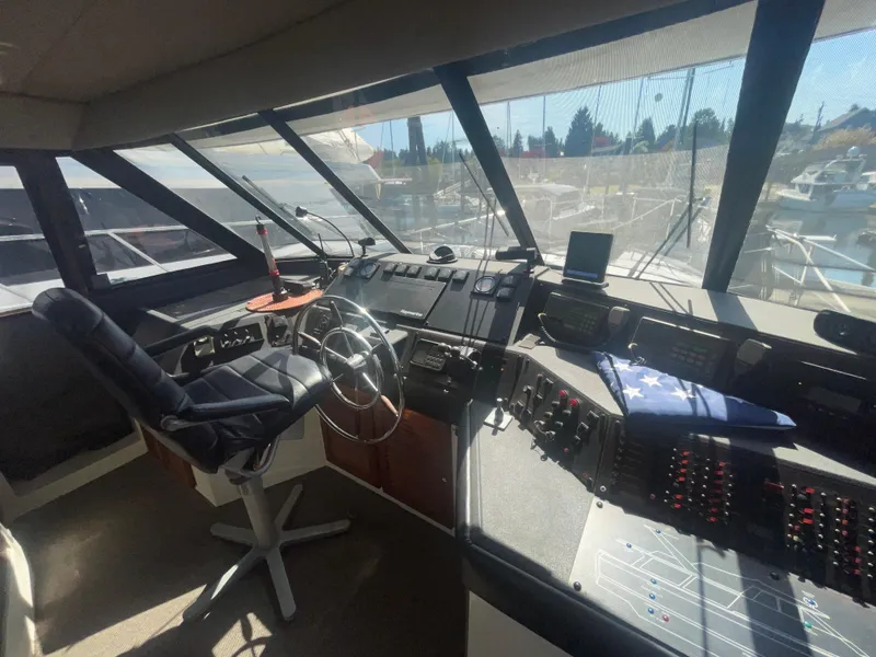 Slide: The Image of 1992 Bayliner 4588 Pilothouse interior with steering wheel, control panels, and panoramic windows. - 15