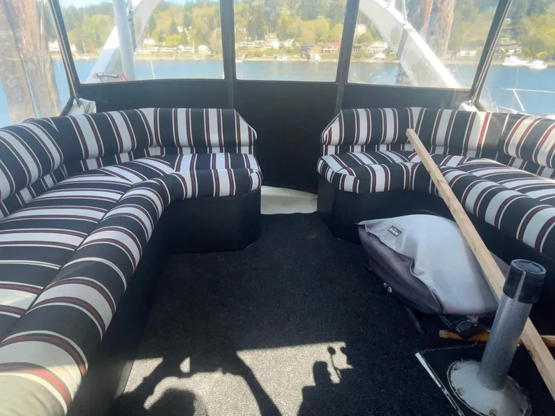 Slide: The Image of Interior of 1992 Bayliner 4588 Pilothouse with striped seating and scenic water view. - 18