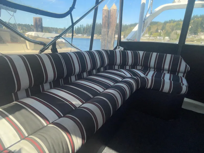 Slide: The Image of Striped seating on 1992 Bayliner 4588 Pilothouse yacht, docked with scenic water view. - 19