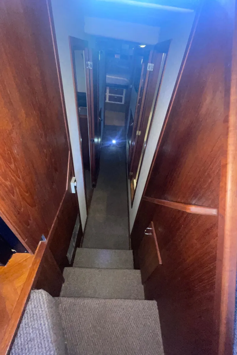 Slide: The Image of Interior hallway of 1992 Bayliner 4588 Pilothouse with wooden paneling and carpeted stairs. - 22
