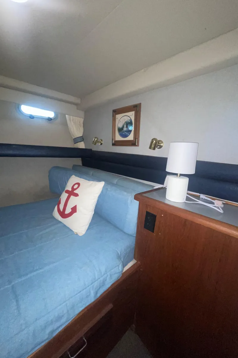 Slide: The Image of Cozy cabin interior of 1992 Bayliner 4588 Pilothouse with nautical decor and soft lighting. - 23