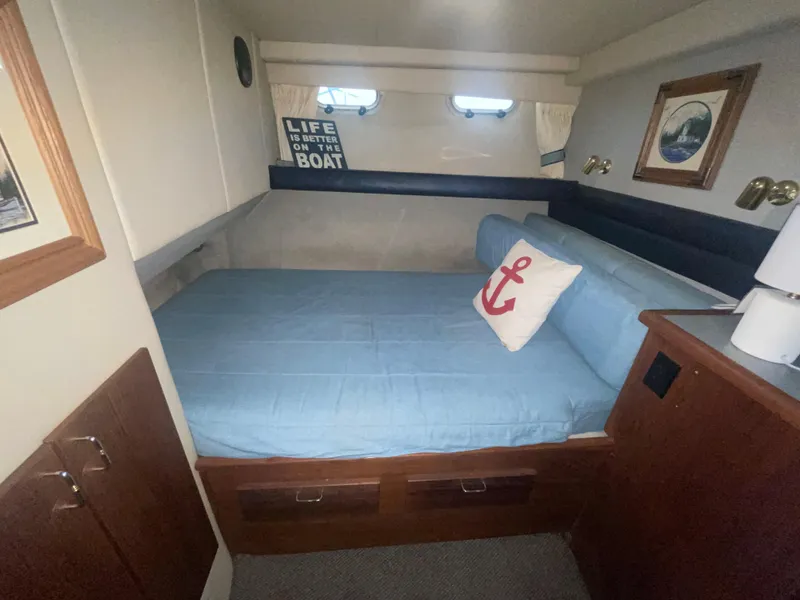 Slide: The Image of Cozy bedroom in 1992 Bayliner 4588 Pilothouse with nautical decor and anchor pillow. - 24