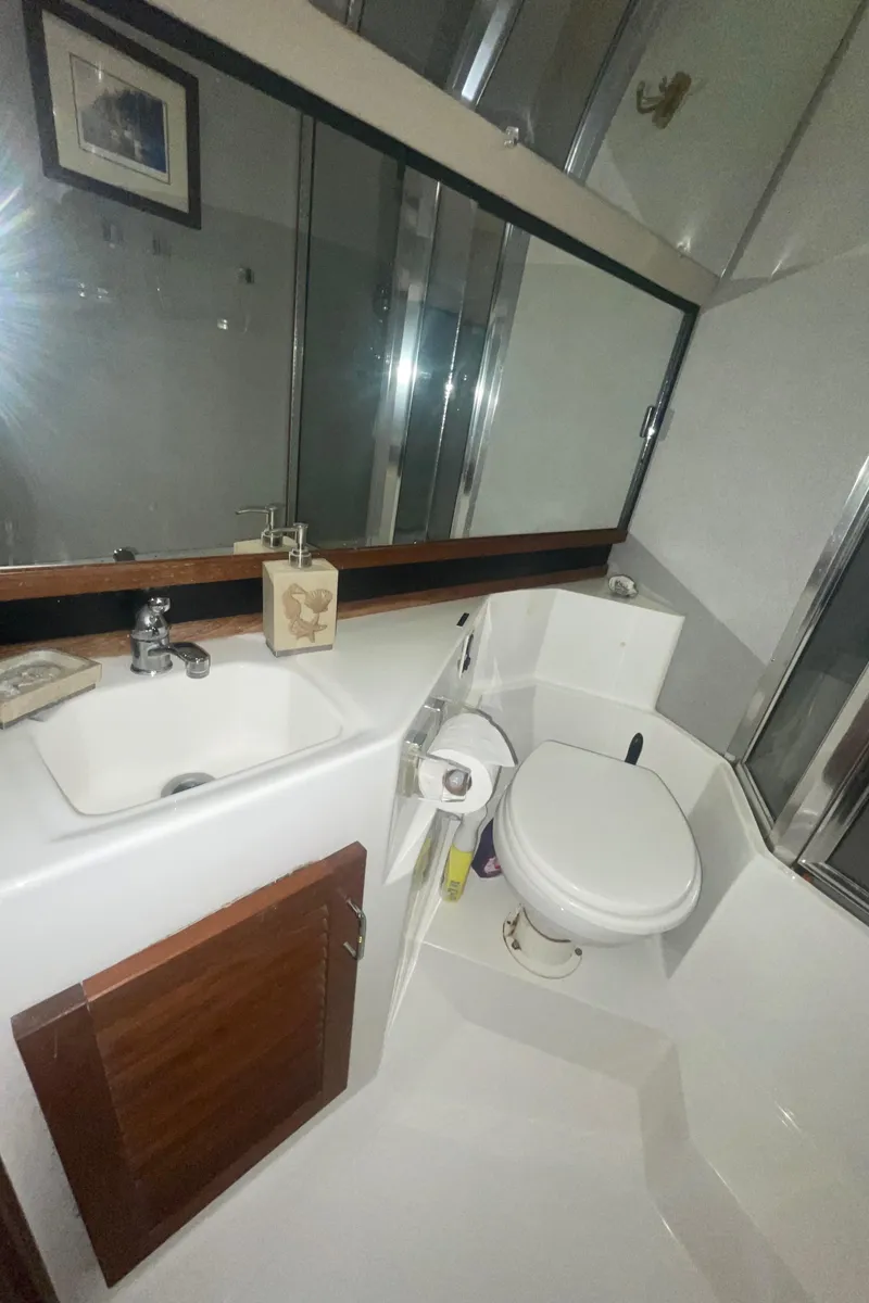 Slide: The Image of Bathroom interior of 1992 Bayliner 4588 Pilothouse yacht, featuring sink and toilet. - 33