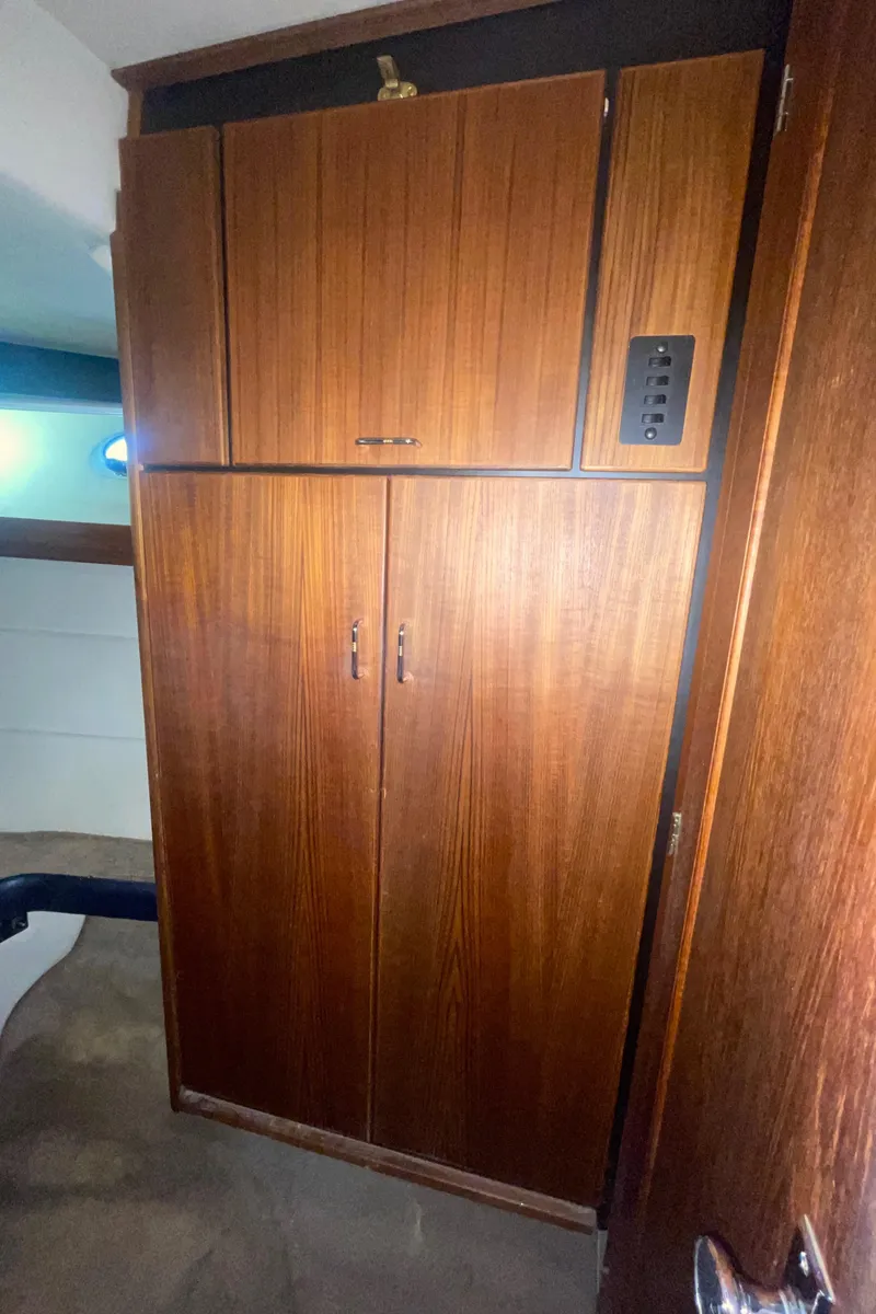 Slide: The Image of 1992 Bayliner 4588 Pilothouse interior wooden cabinet with sleek design. - 34