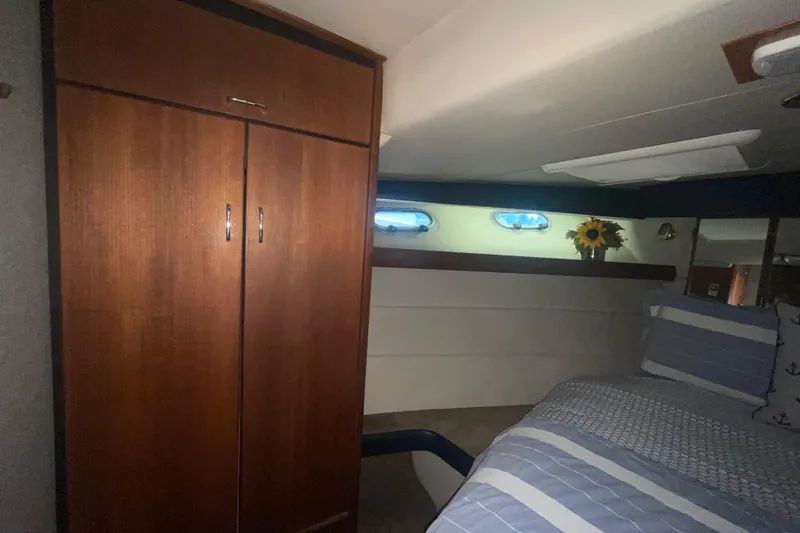 Slide: The Image of Interior cabin of 1992 Bayliner 4588 Pilothouse with bed, wardrobe, and porthole windows. - 35