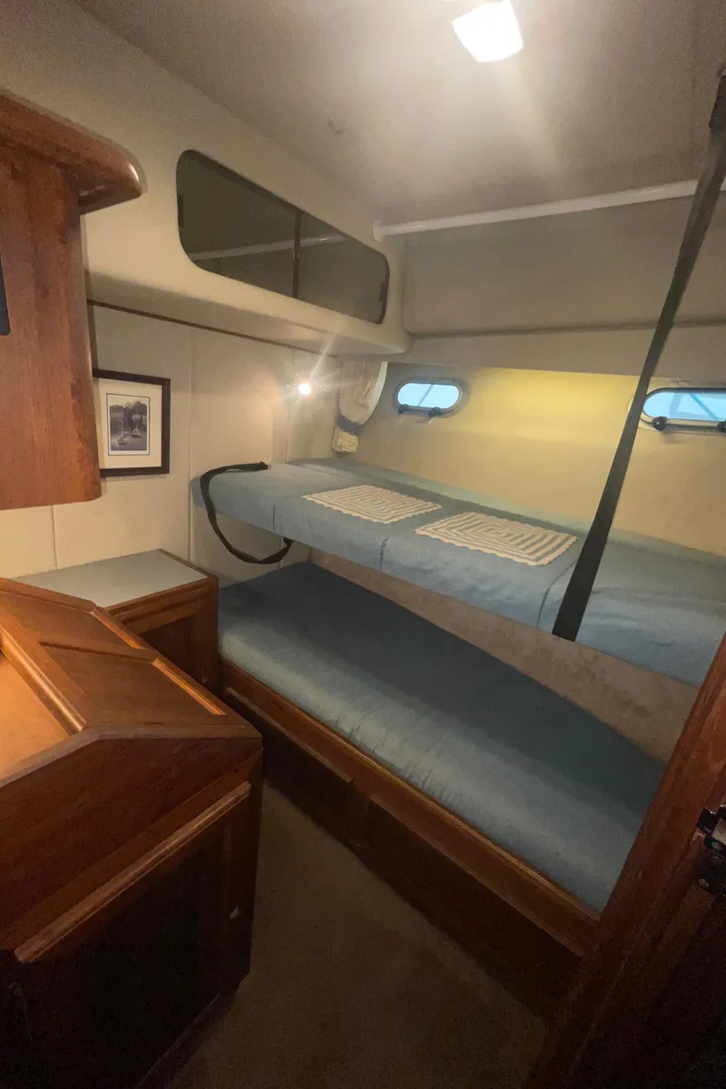 Slide: The Image of 1992 Bayliner 4588 Pilothouse cabin with bunk beds and wooden cabinetry. - 36