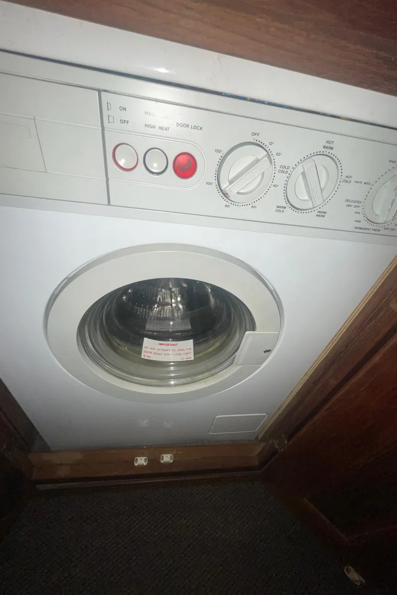 Slide: The Image of Washing machine inside 1992 Bayliner 4588 Pilothouse yacht, featuring control dials and buttons. - 40