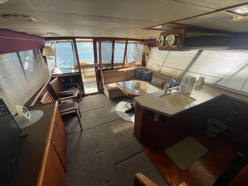 Slide: The Image of Interior of 1992 Bayliner 4588 Pilothouse yacht with spacious seating and kitchen area. - 43