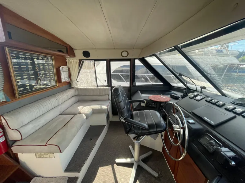 Slide: The Image of 1992 Bayliner 4588 Pilothouse interior with steering wheel, seating, and navigation equipment. - 45