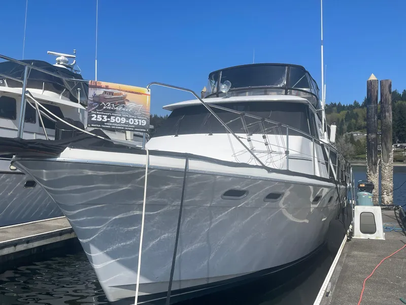 Slide: The Image of Bayliner 4588 Pilothouse 1992 docked at marina under clear blue sky. - 46