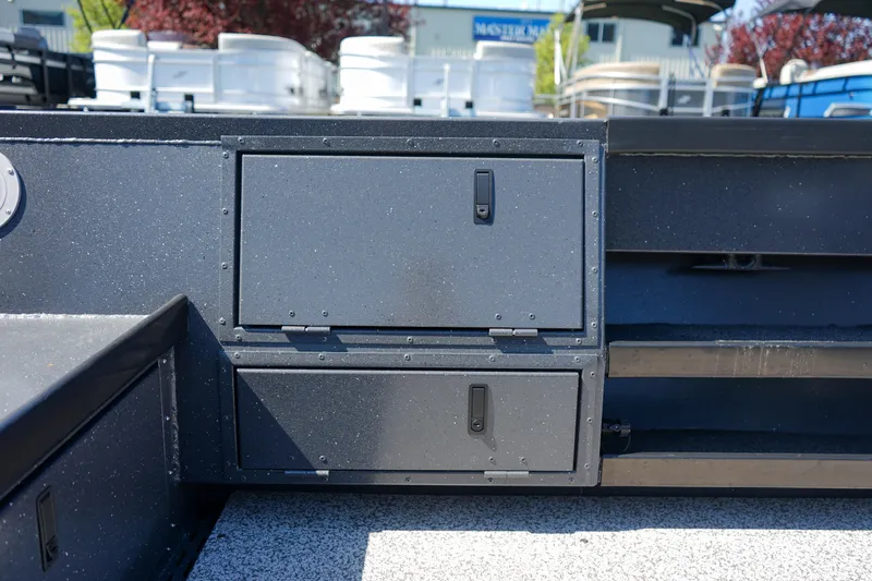 Slide: The Image of 2025 Alumaweld Columbia 23 boat storage compartments, outdoor setting, close-up view. - 11