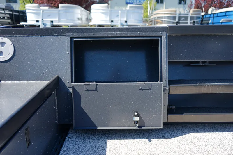 Slide: The Image of ```json
{
"alt_text": "2025 Alumaweld Columbia 23 boat storage compartment detail."
}
``` - 13