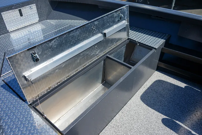 Slide: The Image of Open storage compartment in 2025 Alumaweld Columbia 23 boat, featuring durable metal construction. - 17