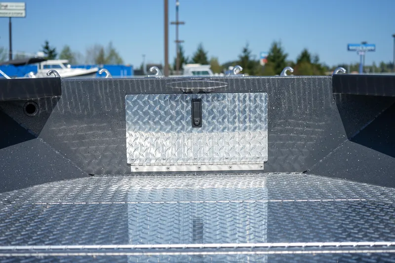 Slide: The Image of 2025 Alumaweld Columbia 23 boat interior with diamond plate flooring and storage compartment. - 20