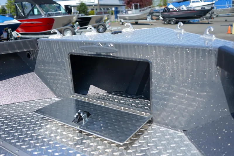 Slide: The Image of 2025 Alumaweld Columbia 23 boat with open storage compartment, showcasing diamond plate flooring. - 21