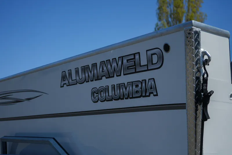 Slide: The Image of 2025 Alumaweld Columbia 23 boat side view with logo and blue sky background. - 22