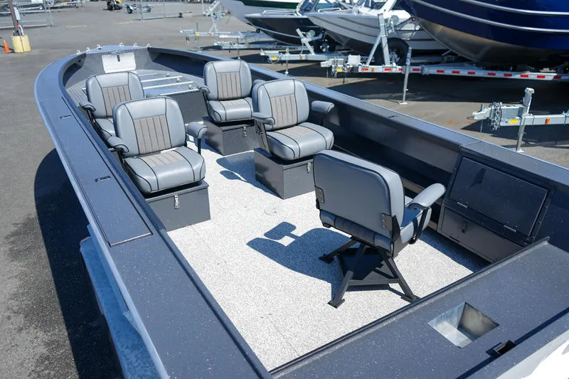 Slide: The Image of 2025 Alumaweld Columbia 23 boat interior with five gray seats, docked outdoors. - 4