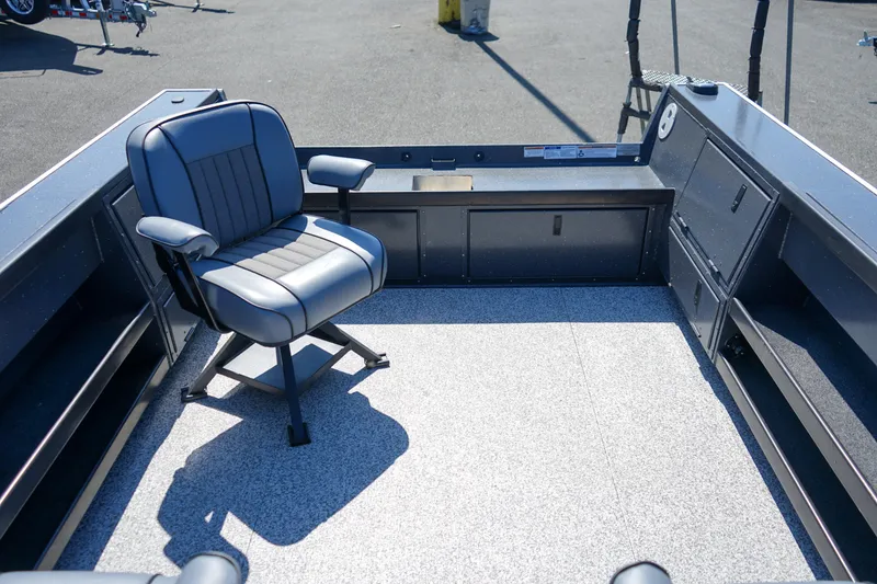Slide: The Image of 2025 Alumaweld Columbia 23 boat interior with a single swivel chair on a textured floor. - 6