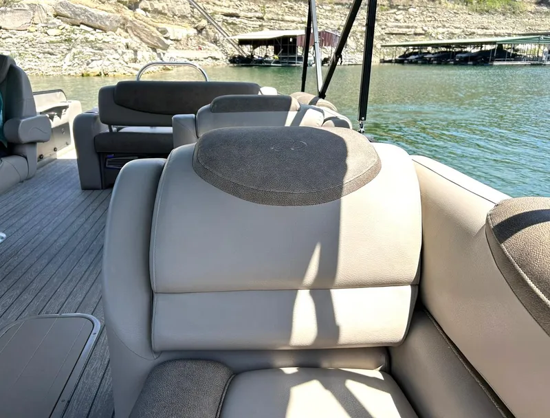 Slide: The Image of 2020 Avalon Catalina 2585 VRB boat interior with plush seating on a sunny day. - 27