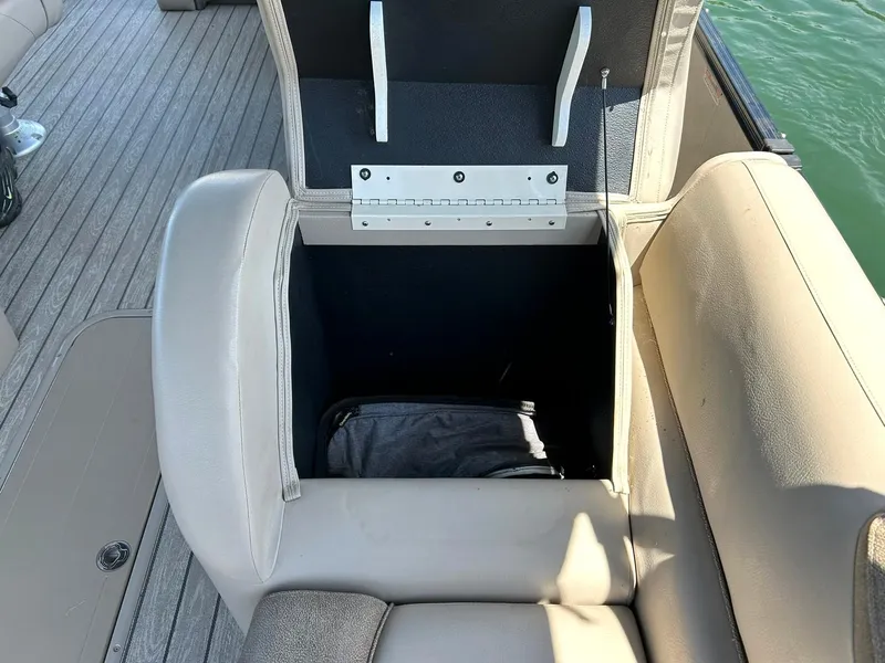 Slide: The Image of Open storage compartment on 2020 Avalon Catalina 2585 VRB boat with beige seating. - 28