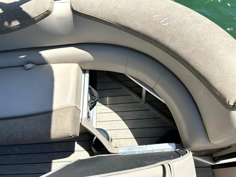 Slide: The Image of 2020 Avalon Catalina 2585 VRB boat interior with cushioned seating and storage compartment. - 29