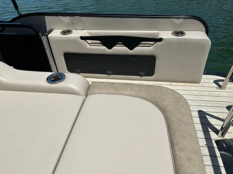 Slide: The Image of 2020 Avalon Catalina 2585 VRB boat interior with seating and cup holders on a sunny day. - 34