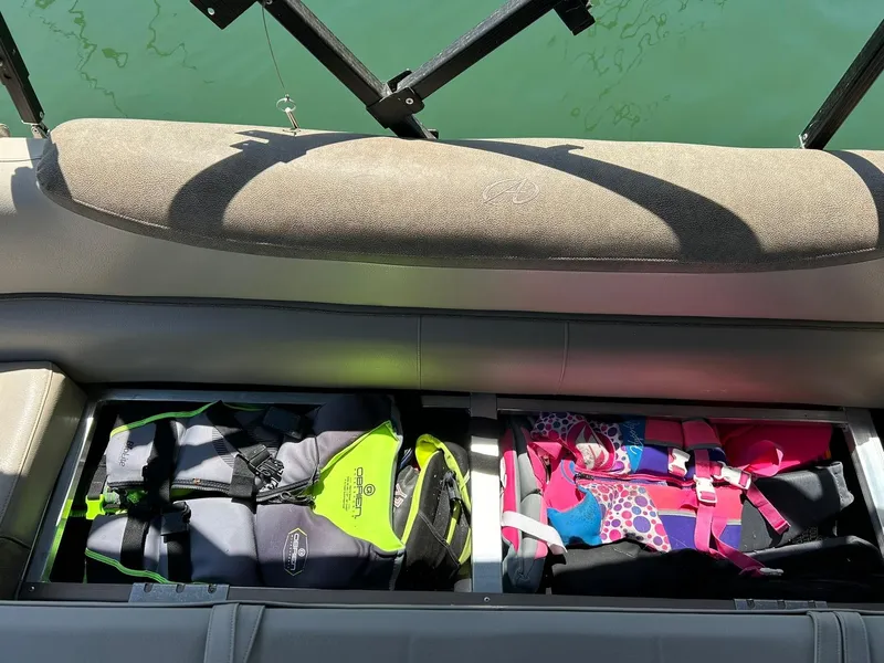 Slide: The Image of Storage compartment with life jackets on a 2020 Avalon Catalina 2585 VRB boat. - 45