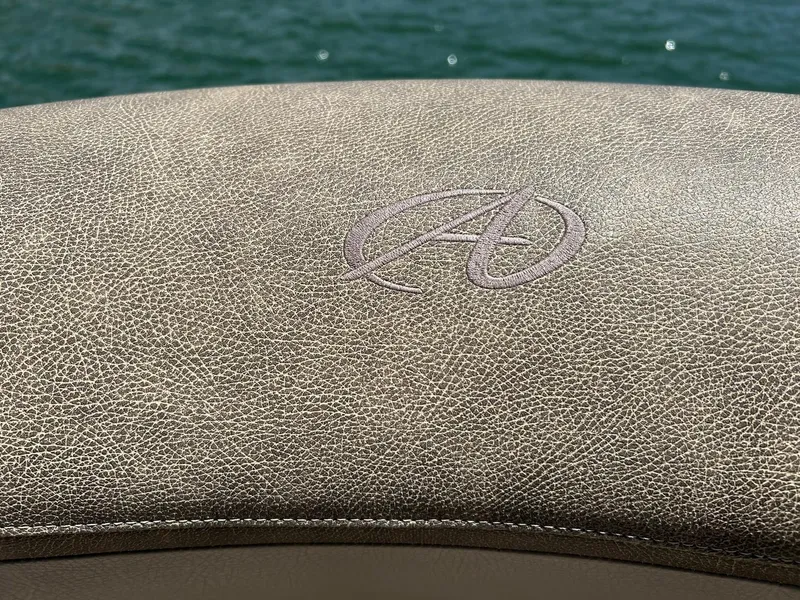Slide: The Image of Luxurious Avalon Catalina 2585 VRB 2020 boat seat with embroidered logo, overlooking water. - 49