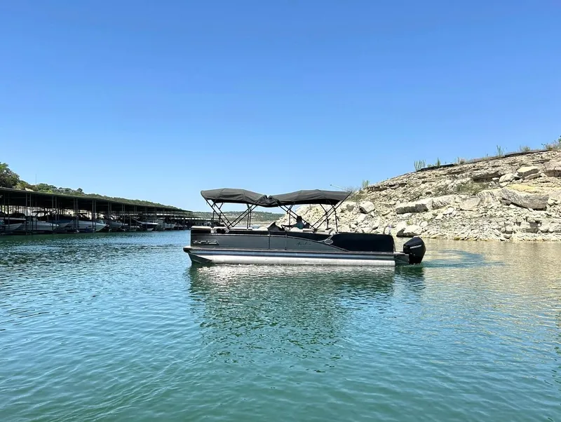 Slide: The Image of 2020 Avalon Catalina 2585 VRB pontoon boat on calm lake water under clear blue sky. - 6
