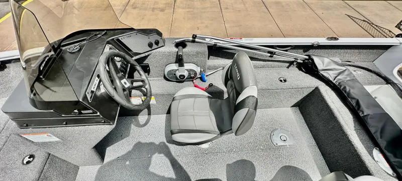 Slide: The Image of 2025 Lund 1650 Rebel XL Sport boat interior with steering wheel and seating. - 10