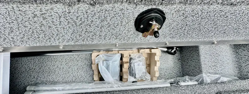 Slide: The Image of 2025 Lund 1650 Rebel XL Sport interior storage compartment with accessories and controls. - 12