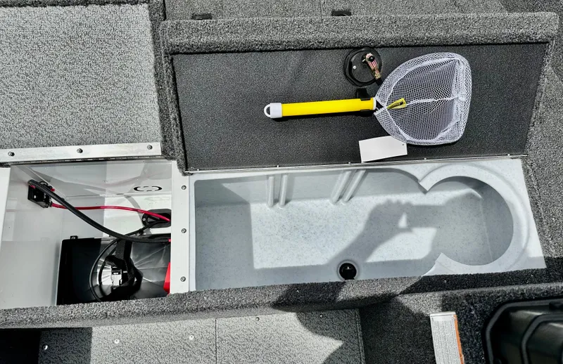 Slide: The Image of 2025 Lund 1650 Rebel XL Sport boat interior with storage compartments and fishing net. - 14