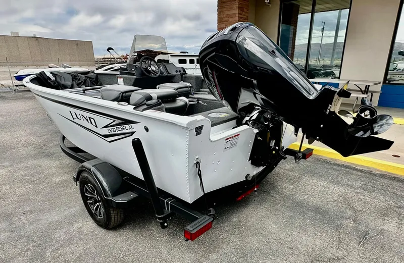 Slide: The Image of 2025 Lund 1650 Rebel XL Sport boat with outboard motor on trailer. - 4