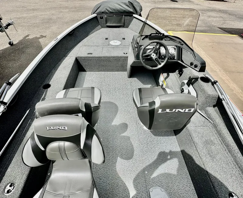 Slide: The Image of 2025 Lund 1650 Rebel XL Sport boat interior with seating and steering console. - 6