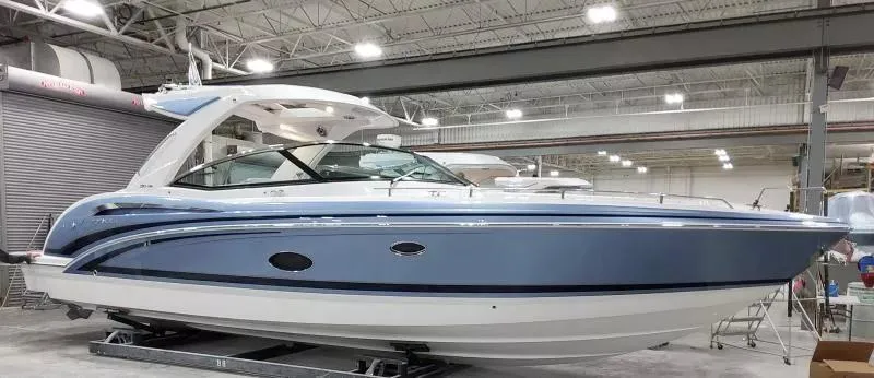 Slide: The Image of 2021 Formula 350 Crossover Bowrider I/O in a showroom, side view. - 1