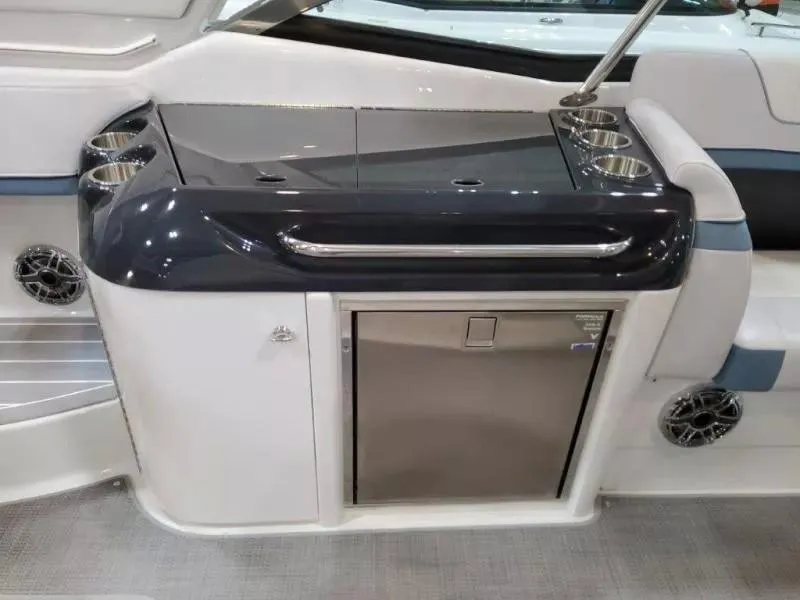 Slide: The Image of 2021 Formula 350 Crossover Bowrider I/O interior with sleek kitchenette and stainless steel accents. - 10