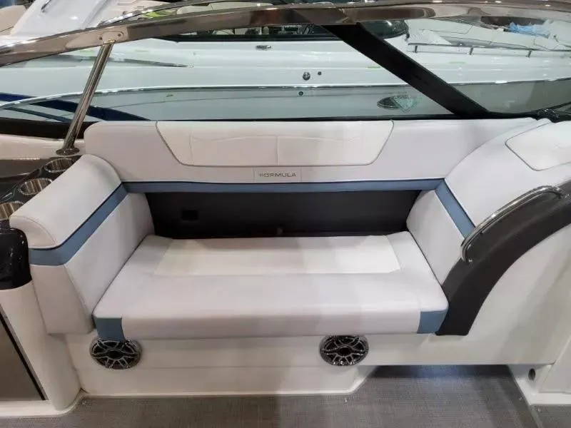 Slide: The Image of 2021 Formula 350 Crossover Bowrider I/O interior seating with white and blue upholstery. - 12