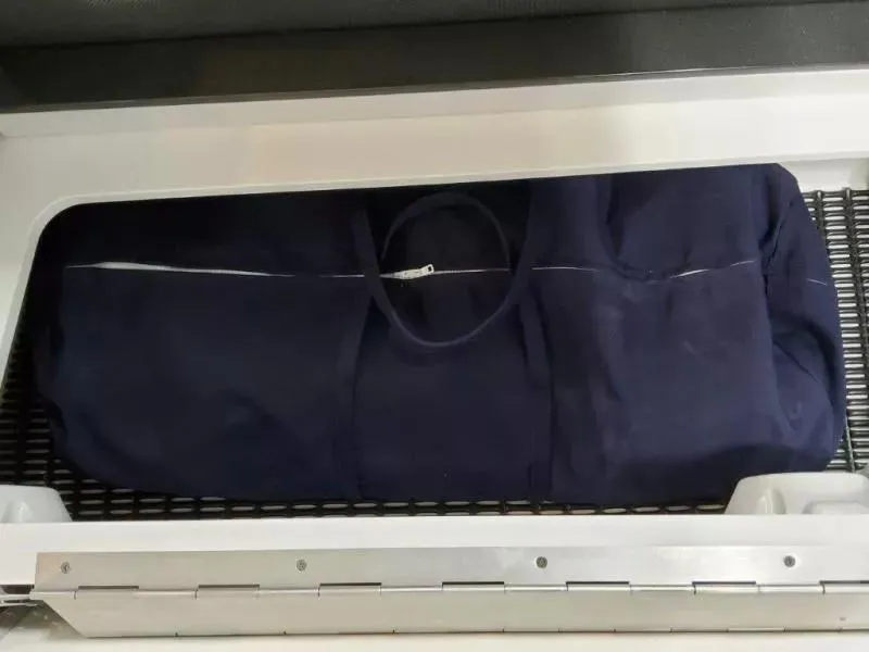 Slide: The Image of Navy blue bag stored in a 2021 Formula 350 Crossover Bowrider I/O compartment. - 19