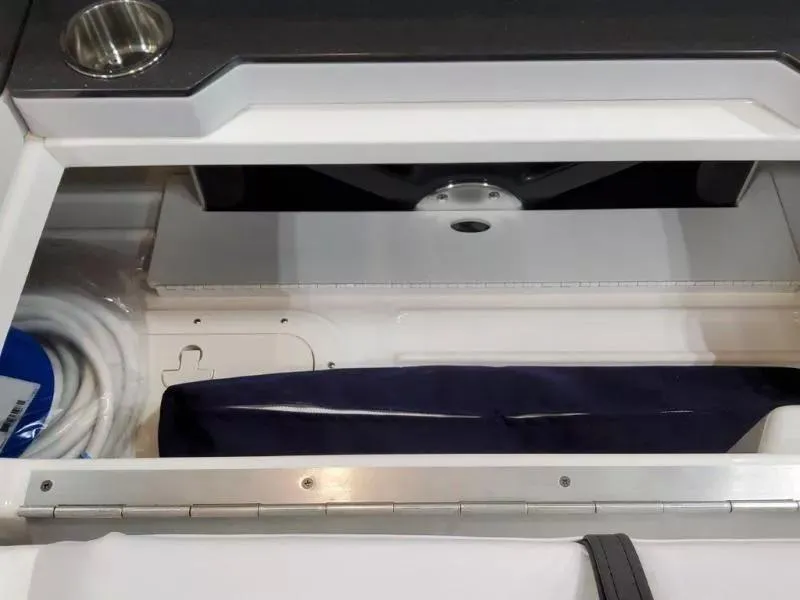 Slide: The Image of 2021 Formula 350 Crossover Bowrider I/O storage compartment with cup holder and accessories. - 20
